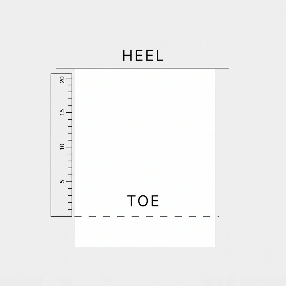 Ruler measuring the paper from the Heel to the Toe mark.